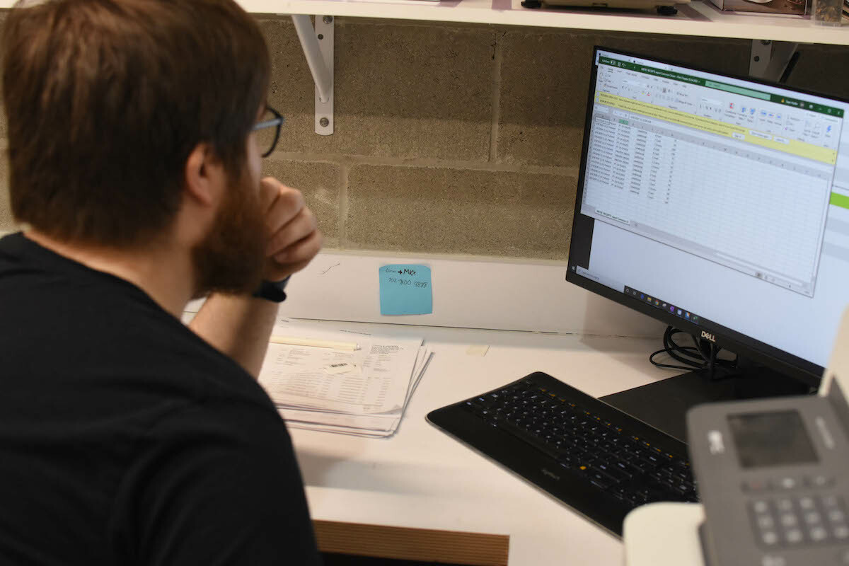 A dispensary employee processes accounting