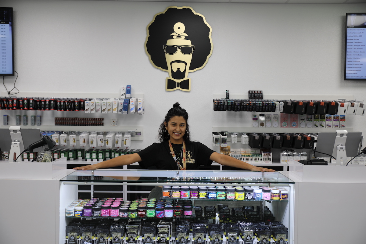 a dispensary employee stands over inventory