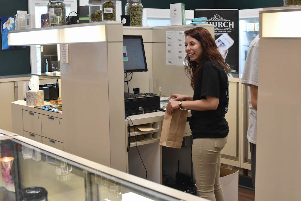 A budtender processes a cannabis transaction at the Releaf Center in Niles, MI.